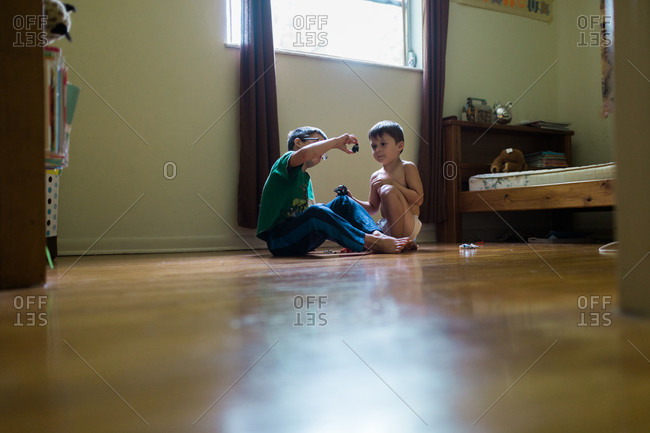 Two Young Brothers Playing On Bedroom Floor Stock Photo Offset