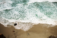 Waves on a rugged ocean beach from above