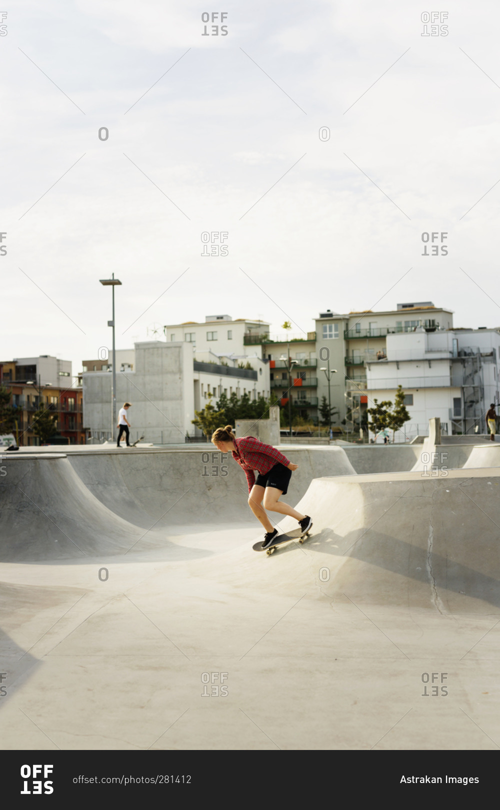 Young woman riding a skateboard at an urban skate park