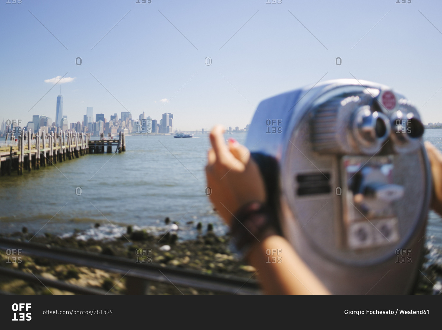 View to the skyline with person using coin operated binoculars in the foreground, New York City