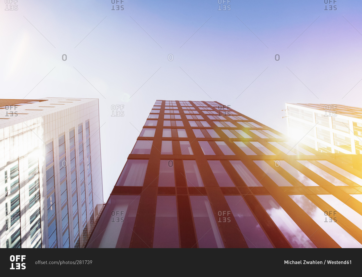 Bright sunshine reflecting in glass facades of modern office buildings