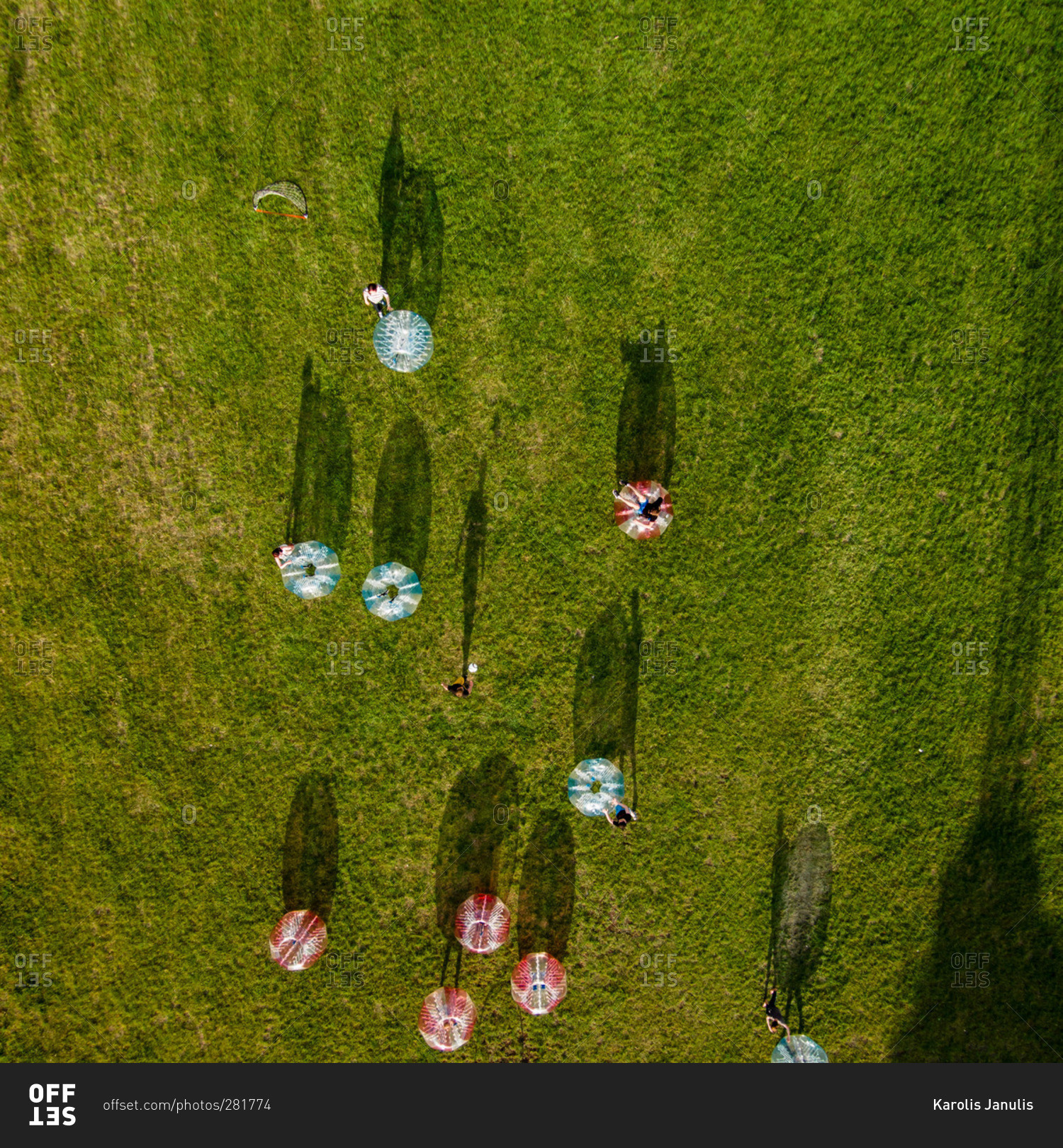 People rolling inside inflatable balls in Lithuanian park stock photo OFFSET