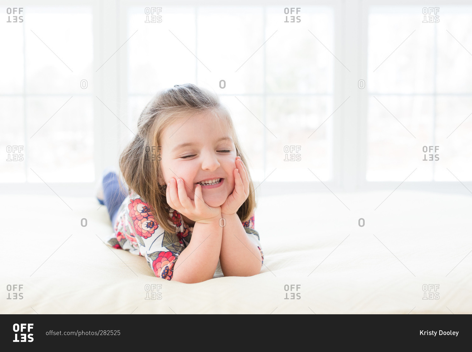 Little girl making a cute face stock photo - OFFSET