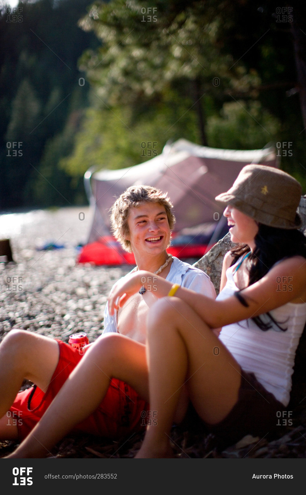 Friends camping and hanging out while camping along shore of Lake Pend Oreille, Idaho