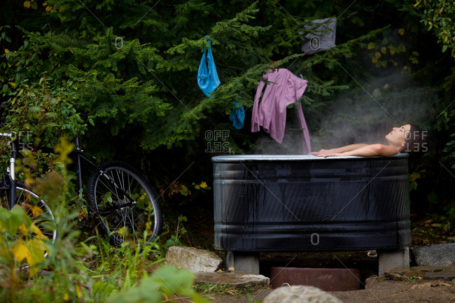 Woman soaks in wood-fired hot water