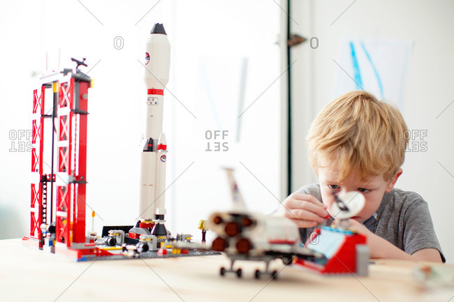 Boy playing with space toy set