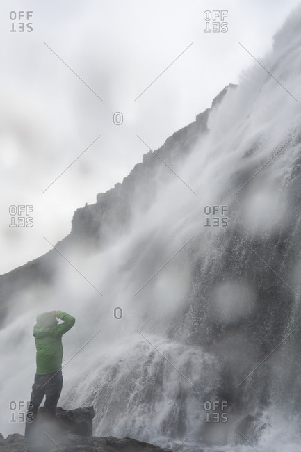 Man looking at waterfall in Iceland
