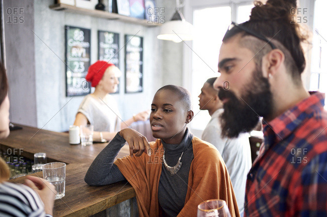 Friends having a conversation at a bar