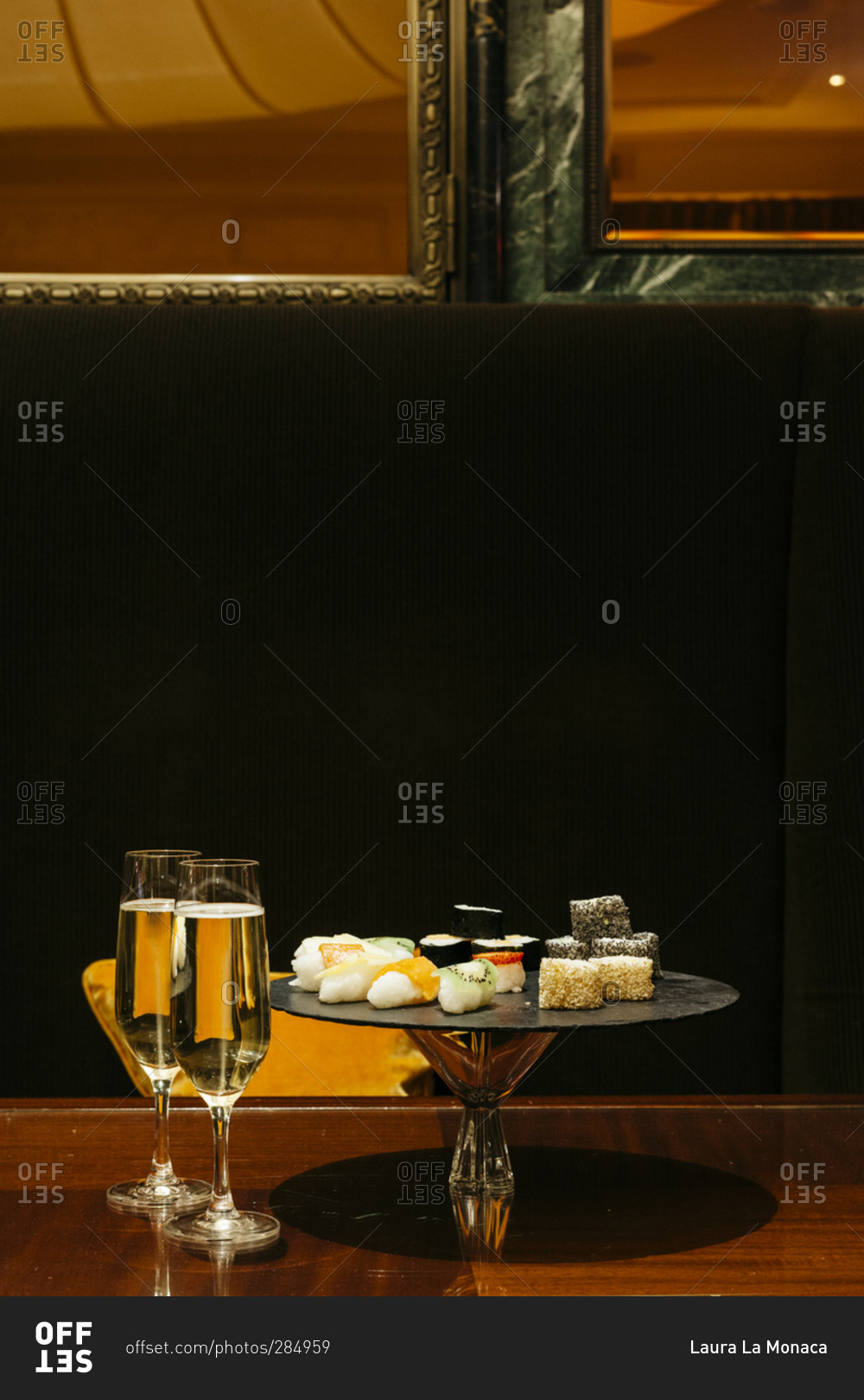 Champagne and dessert sushi on a wooden table