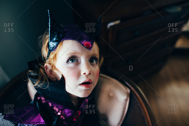 Young girl in makeup and Halloween costume