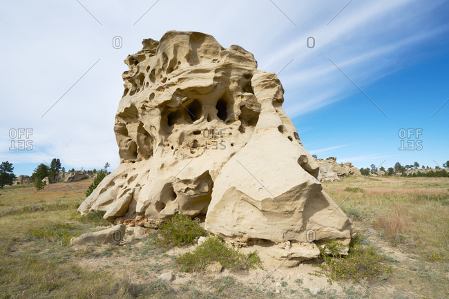 Large eroded rock formation in a field