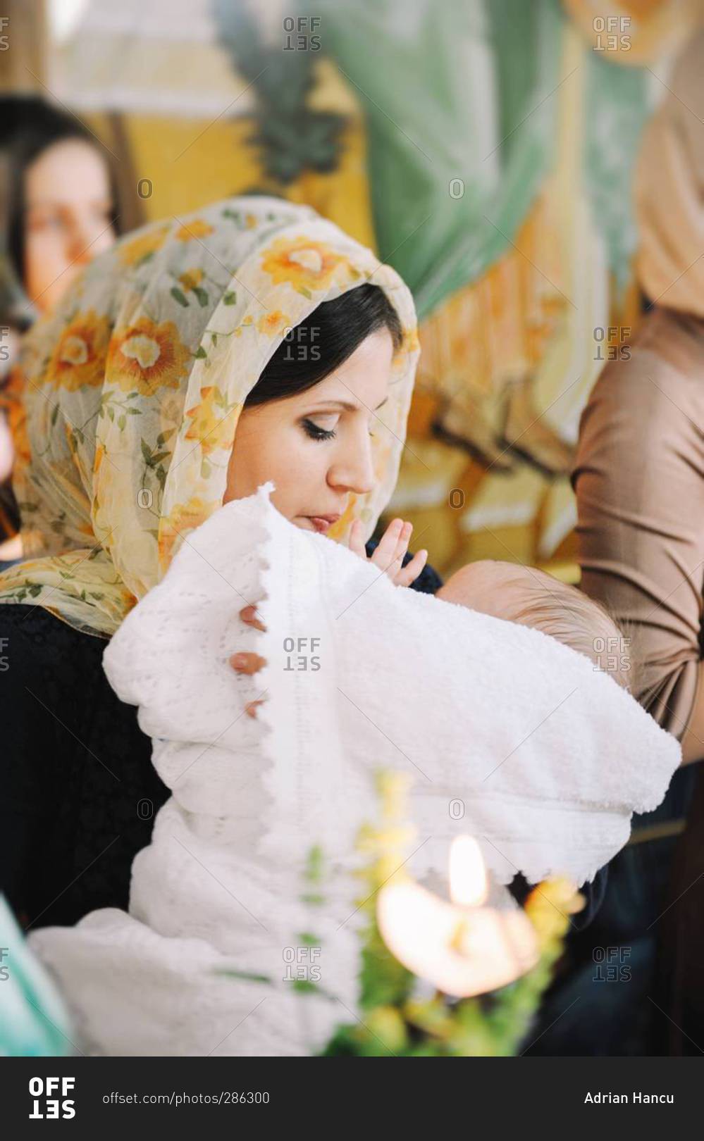 Mother with baby boy after Orthodox Christian Baptism in Chisinau, Moldova