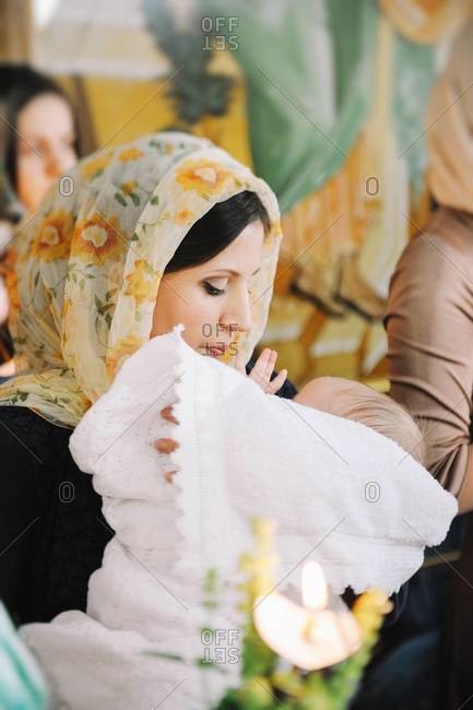 Mother with baby boy after Orthodox Christian Baptism in Chisinau, Moldova