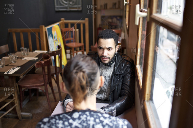 Couple sitting inside a restaurant talking