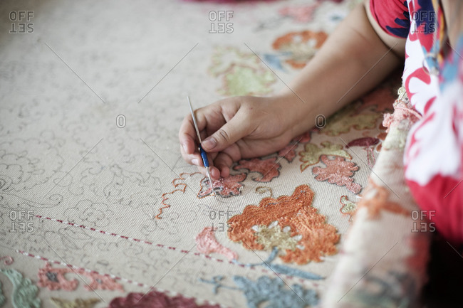 Woman working on an embroidered cloth, Uzbekistan
