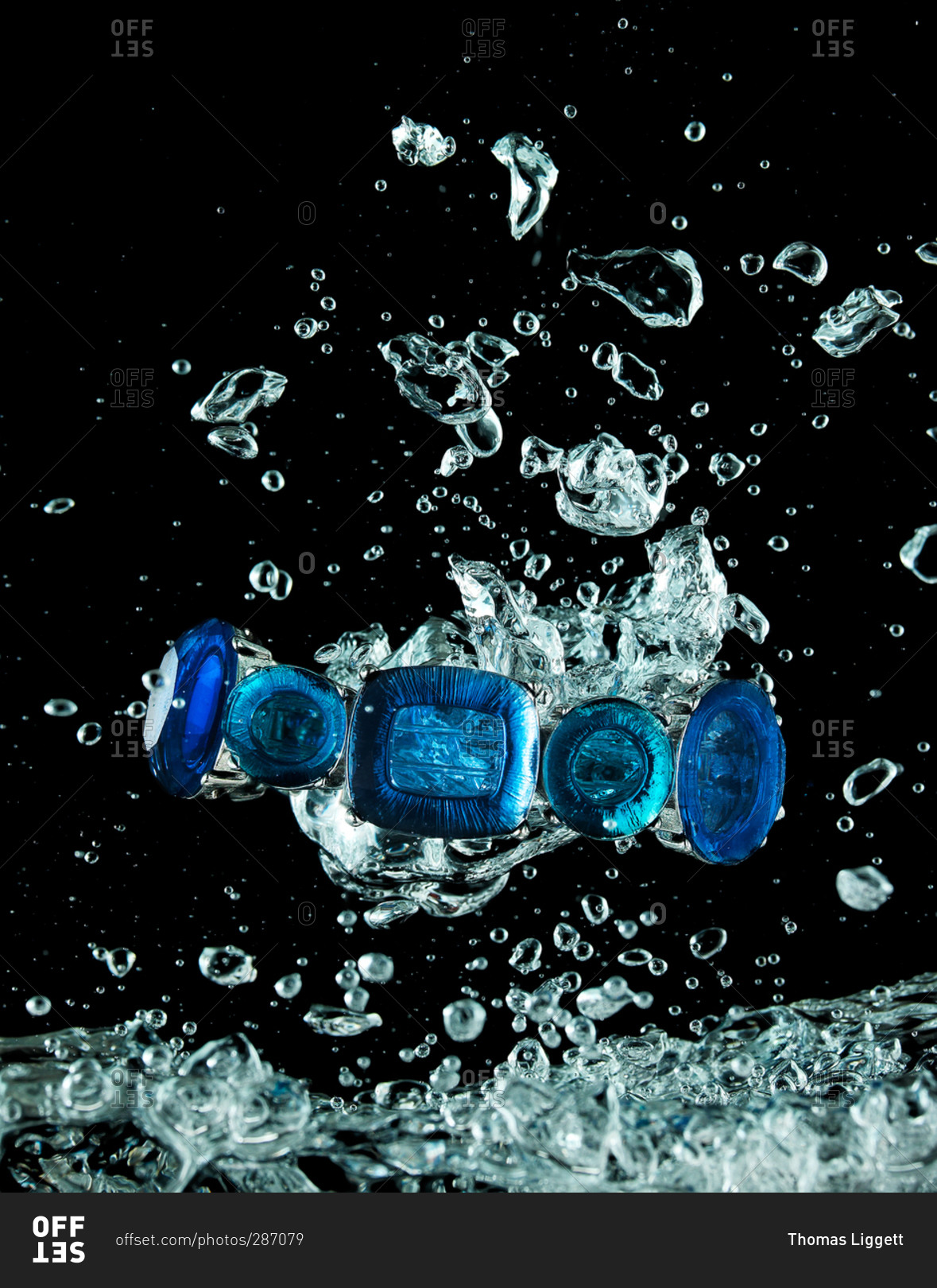 Sapphire jewelry splashing through water
