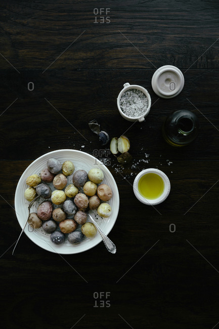 Plate of small baked potatoes and seasonings