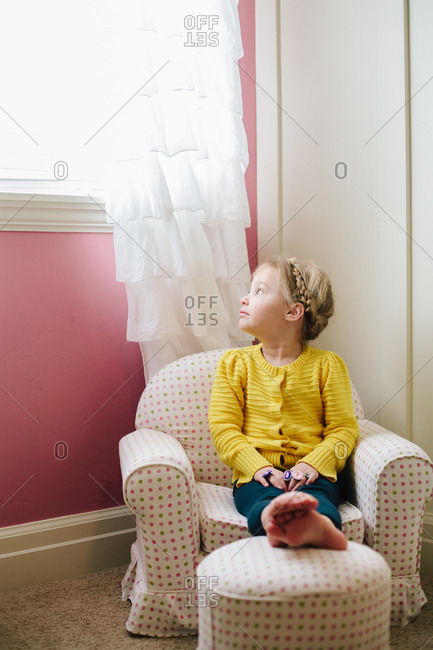Little Girl Sitting In A Child Sized Chair Stock Photo Offset