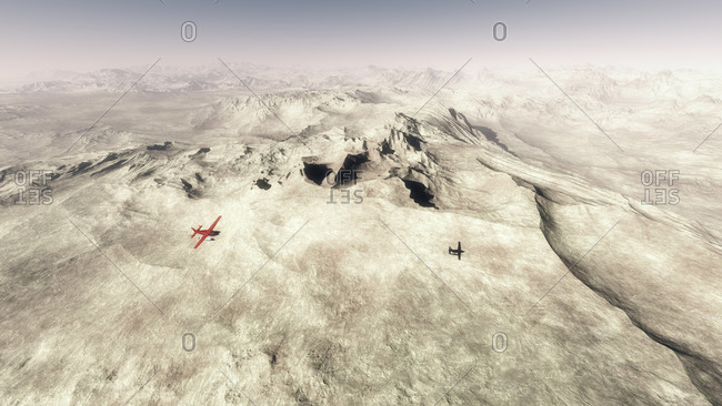 Red single engine airplane flying over barren mountain landscape