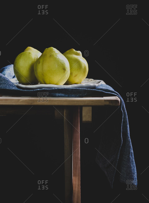 Three quince fruits on a table