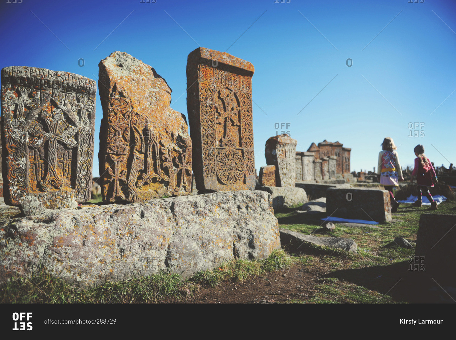 Girls exploring traditional Armenian graveyard