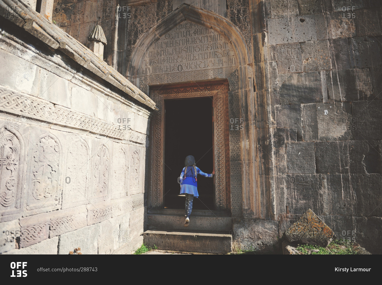 Girl going in door of Armenian monastery