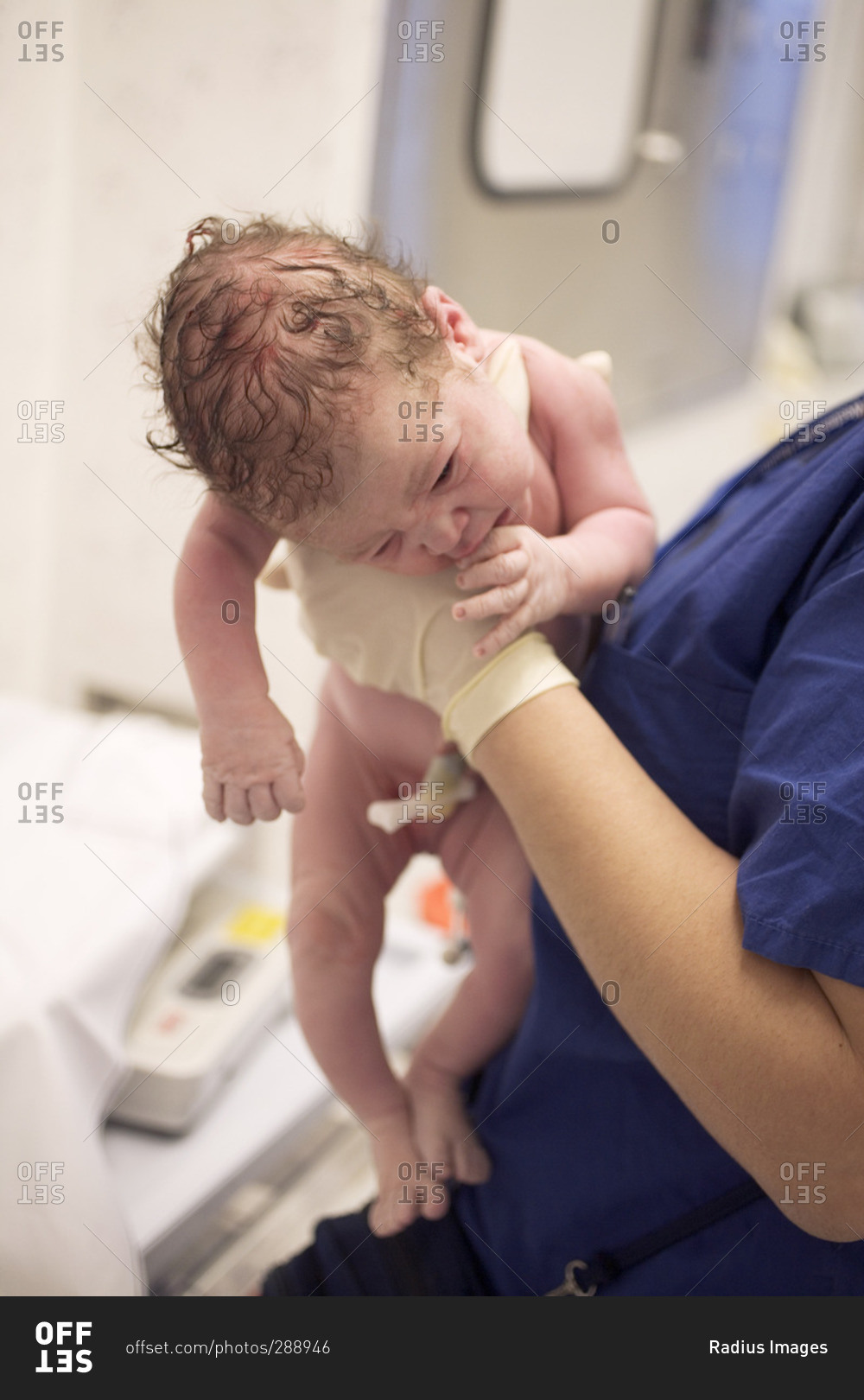 Nurse Holding Newborn Baby