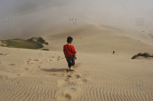 Boy Walking on Sand Dunes, Siuslaw National Forest, Oregon, USA