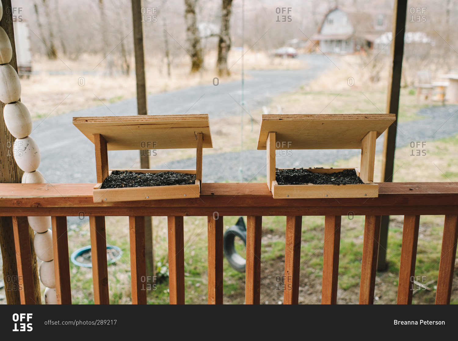 Bird feeders on a porch railing