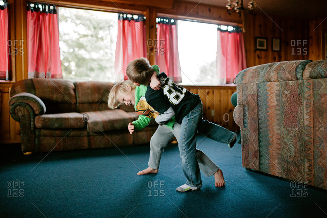 Young boys play wrestling