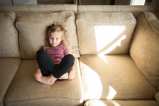 little girl sitting cross legged side view