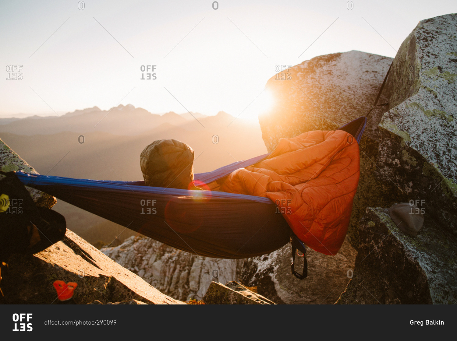 Person camping in a hammock waking up to the sunrise on the Laugavegur Trail, Iceland
