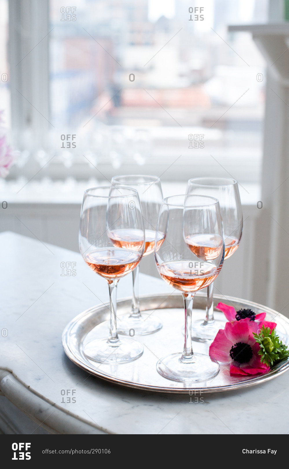 Wine glasses on a serving tray with pink flowers