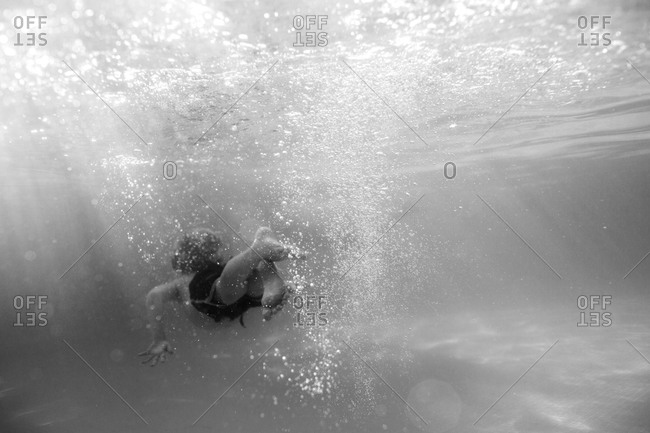 Boy swimming underwater in Huatulco, Mexico