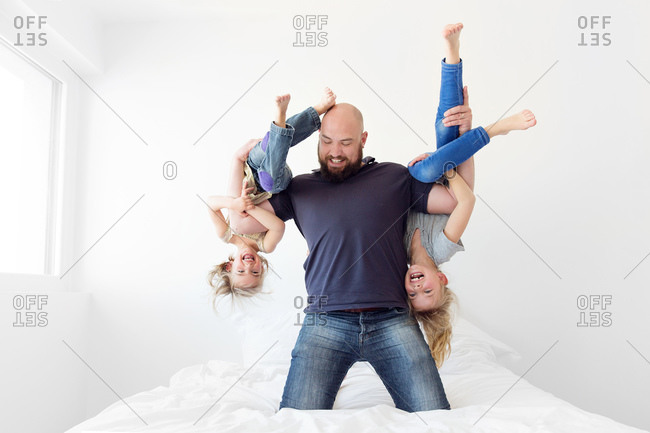 Father wrestling with this daughters at home