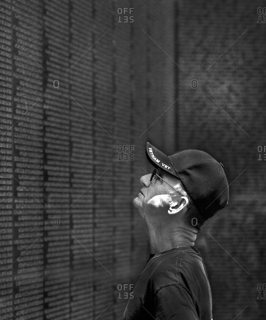 Washington, D.C., USA - May 22, 2014: Man looking at the names on the Vietnam Memorial Wall, Washington, D.C.