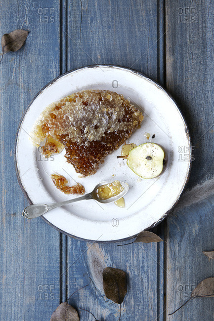 Honeycomb and fresh pear on a plate