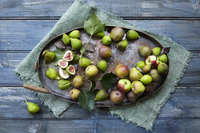 Fresh-picked autumn fruit on a rusted metal platter