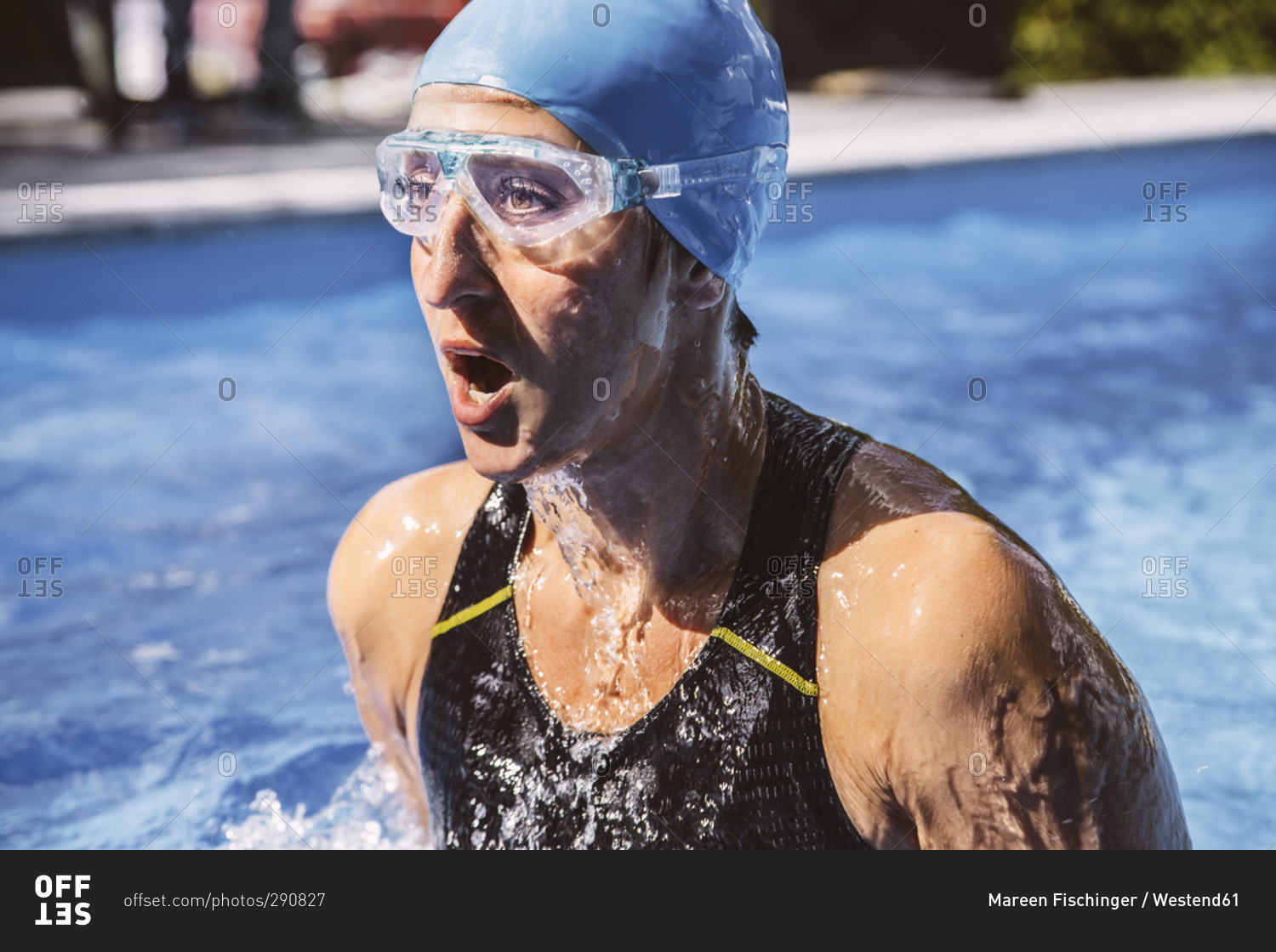 Female triathlete taking a deep breath while swimming