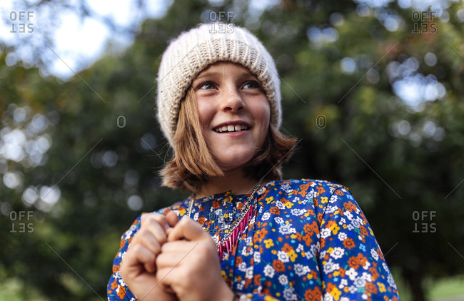 Smiling girl wearing woolen cap looking over her shoulder