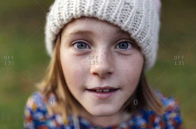 Up close portrait of smiling girl wearing woolen cap