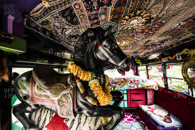 Cottekill, New York - July 24, 2014: Rocking horse inside of a school bus at Kat O'Sullivan's technicolor home