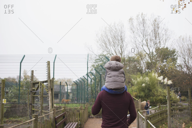Blackpool, UK - November 1, 2015: Boy sitting on his father's shoulders at a zoo