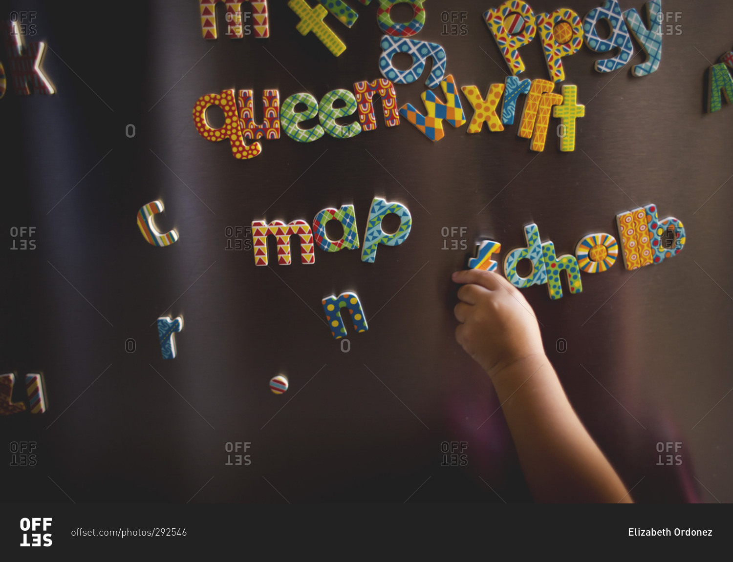 Close up of a little girl playing with letter magnets