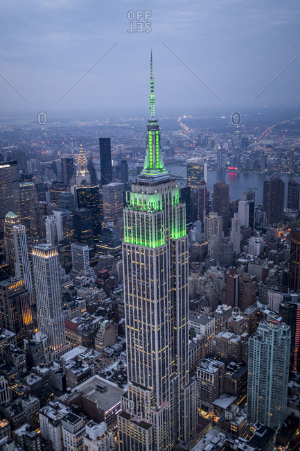 New York City, NY, USA - May 5, 2015: The Empire State Building illuminated with green light at night, Manhattan, New York City, NY