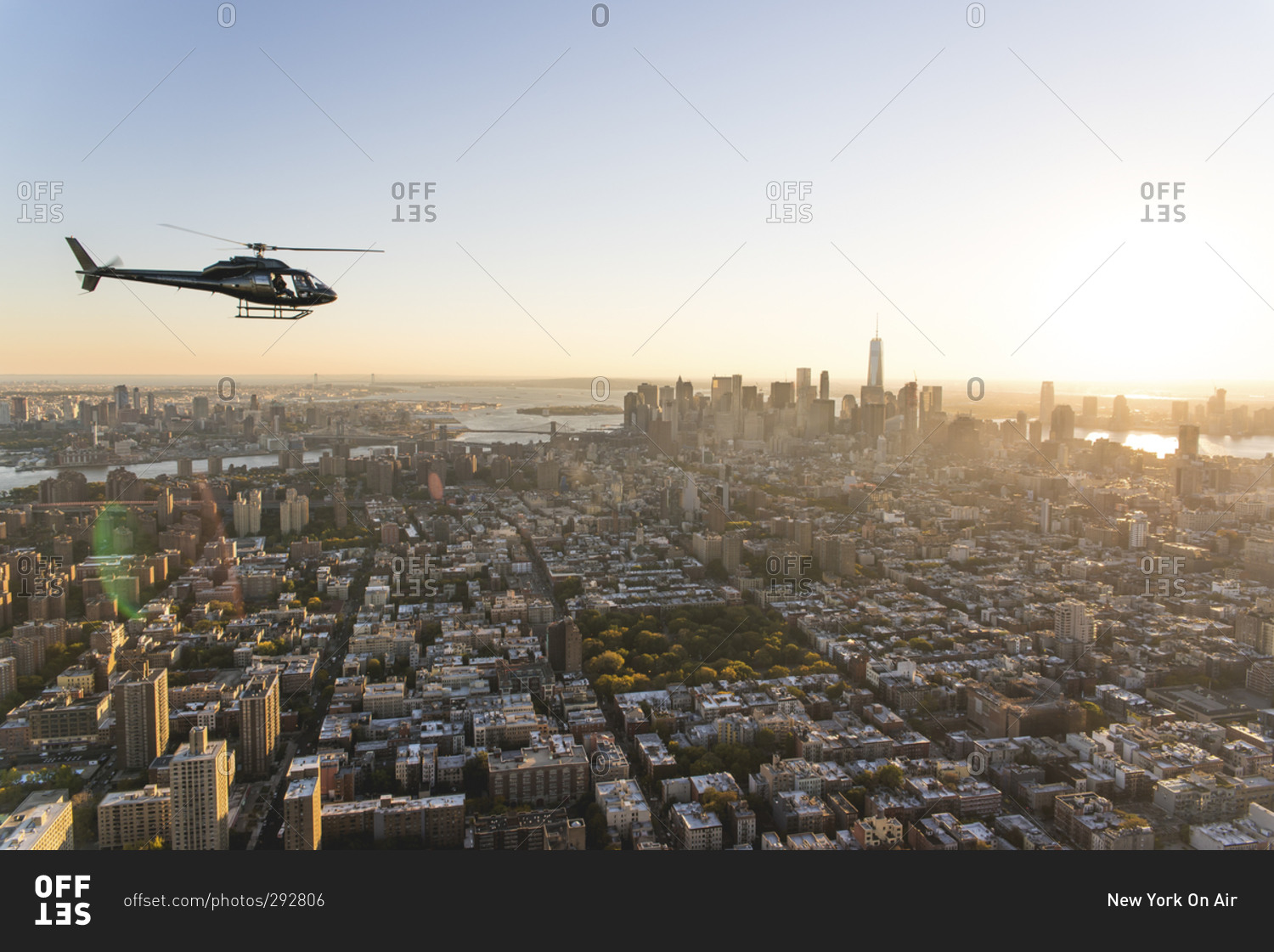 Helicopter flying over the island of Manhattan at sunset, New York City, NY