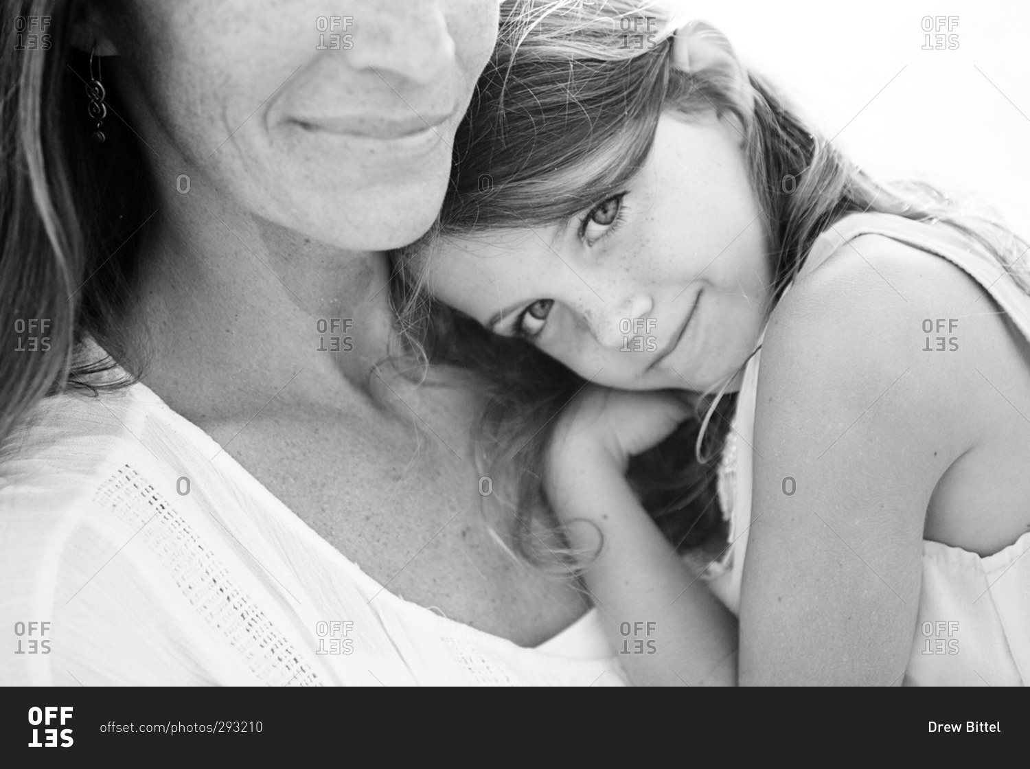 Beautiful young girl resting her head on mother's shoulder stock photo ...