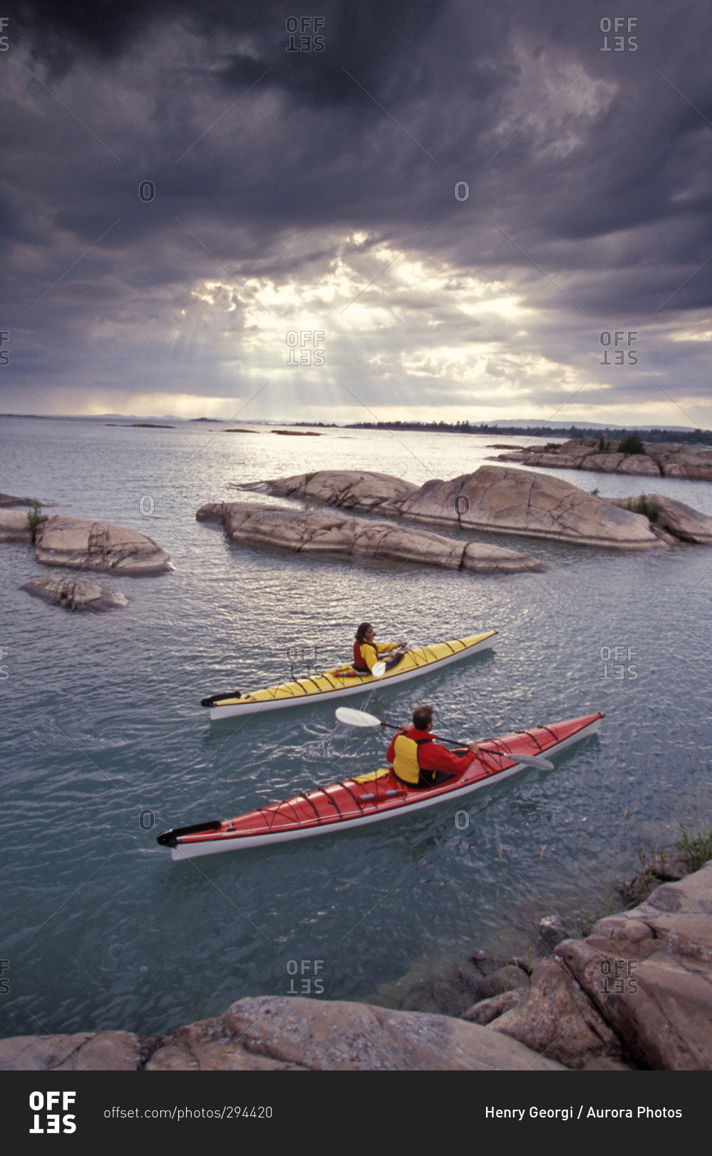 Young couple sea-kayak after a storm on Georgian Bay, Lake Huron, Ontario, Canada