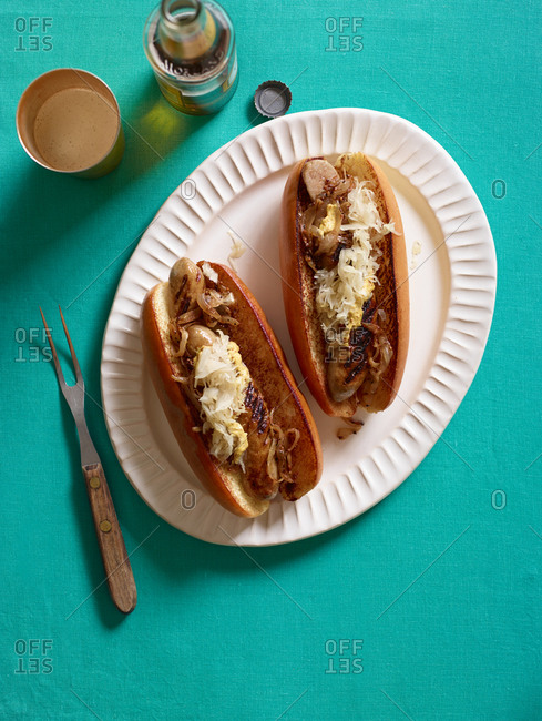 Two Italian sausages on buns with sauerkraut