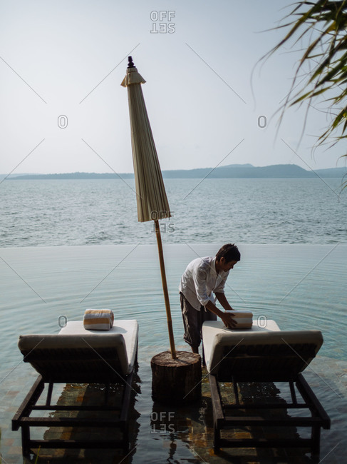 Koh Rong Island, Cambodia - October 27, 2015: Man preparing coastal seating in Cambodia